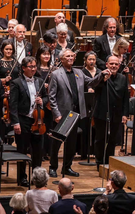 John Corigliano and Jaap van Zweden acknowledge applause following the the New York Philharmonic's performance of Corigliano's Symphony No. 1 Thursday night at David Geffen Hall. Photo: Chris Lee